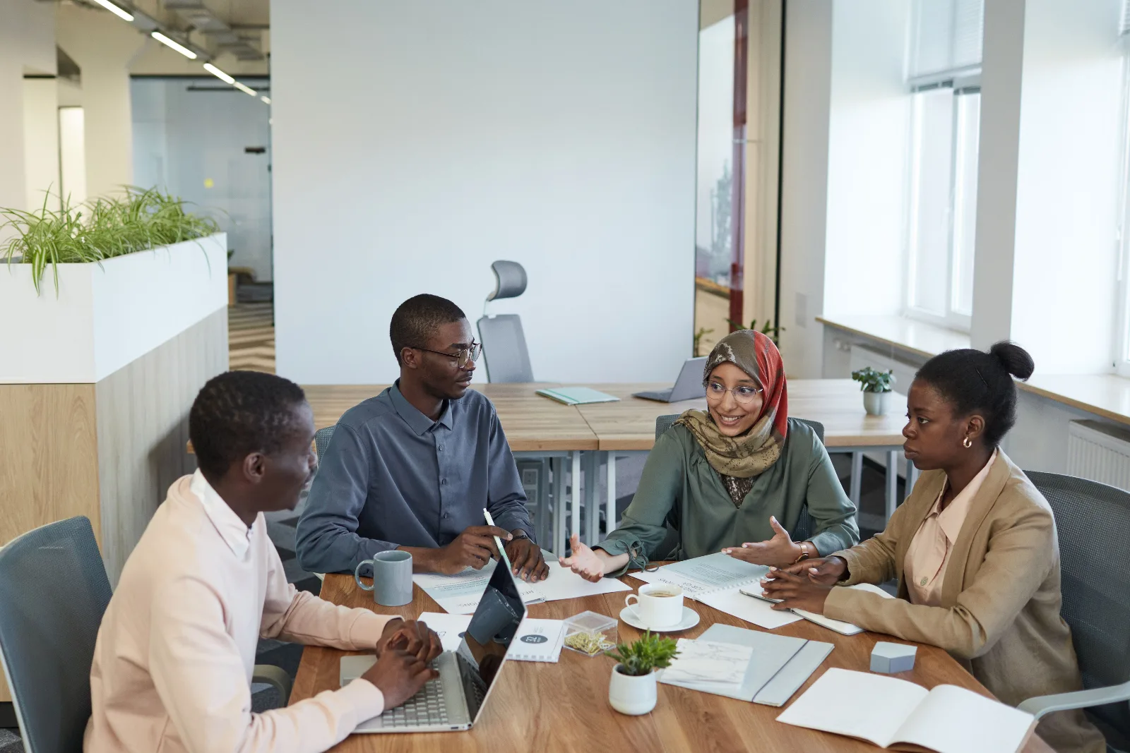 African professionals exchange ideas during a workplace networking conversation.