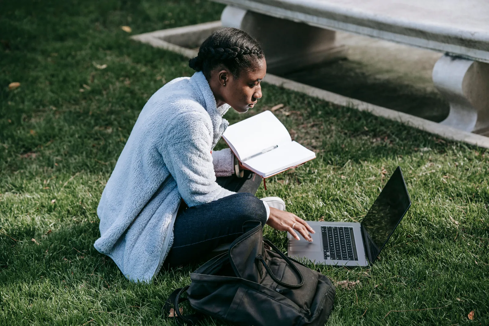 A young African professional develops new skills through online learning on a laptop.