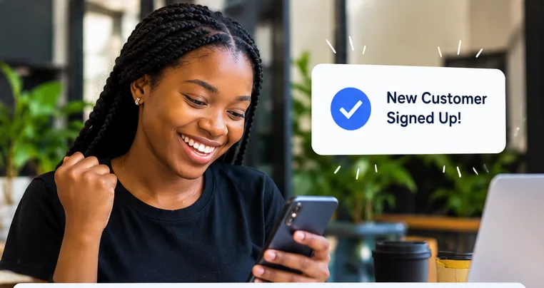 A startup founder celebrates receiving a new customer signup.