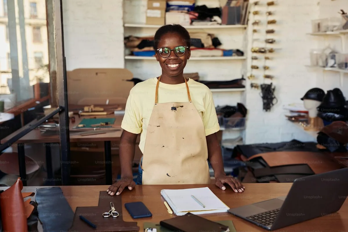 An African entrepreneur using a laptop to manage an online business, illustrating the importance of building customer relationships and managing business operat